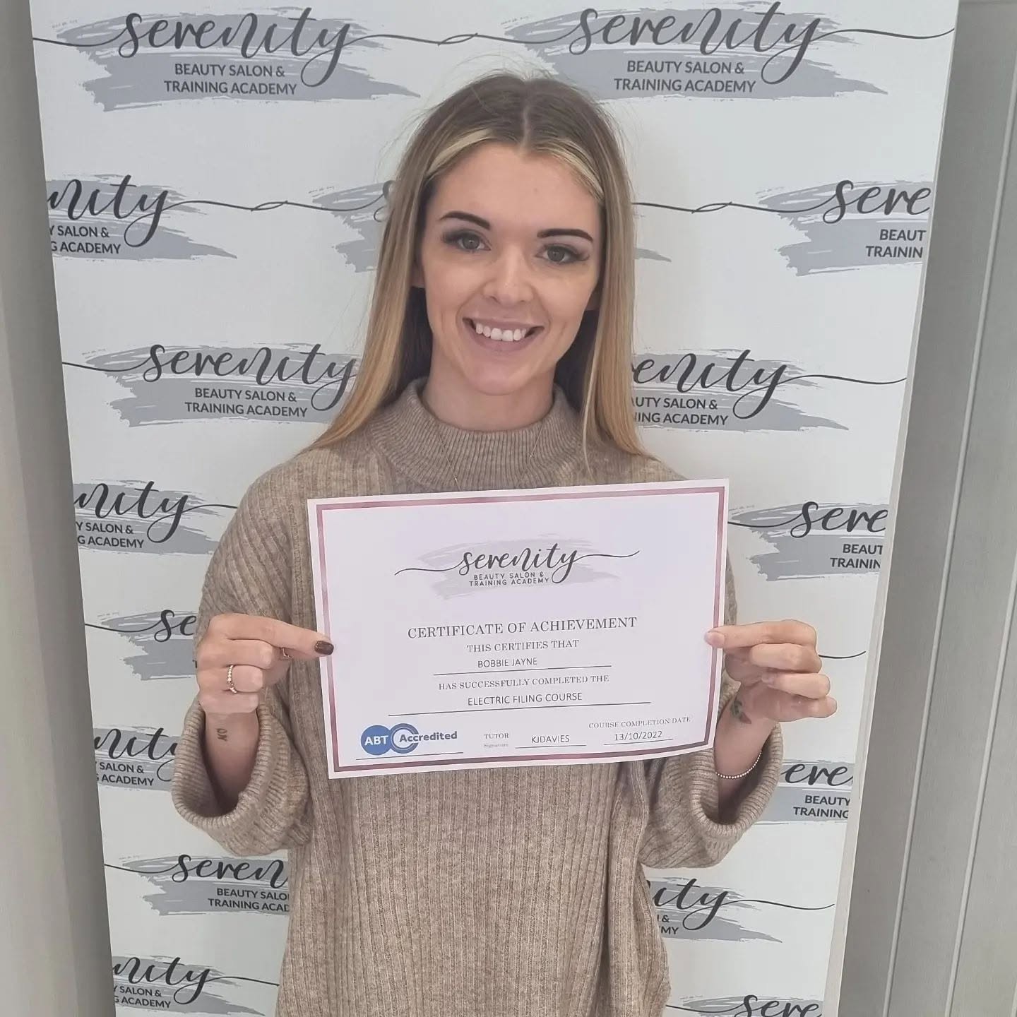 A Serenity Training Academy graduate with her certificate