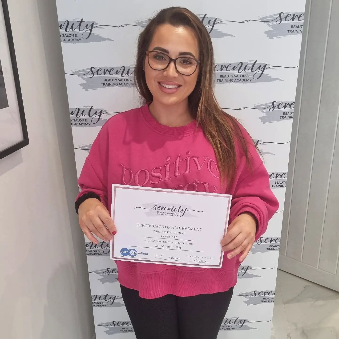 A Serenity Training Academy graduate with her certificate