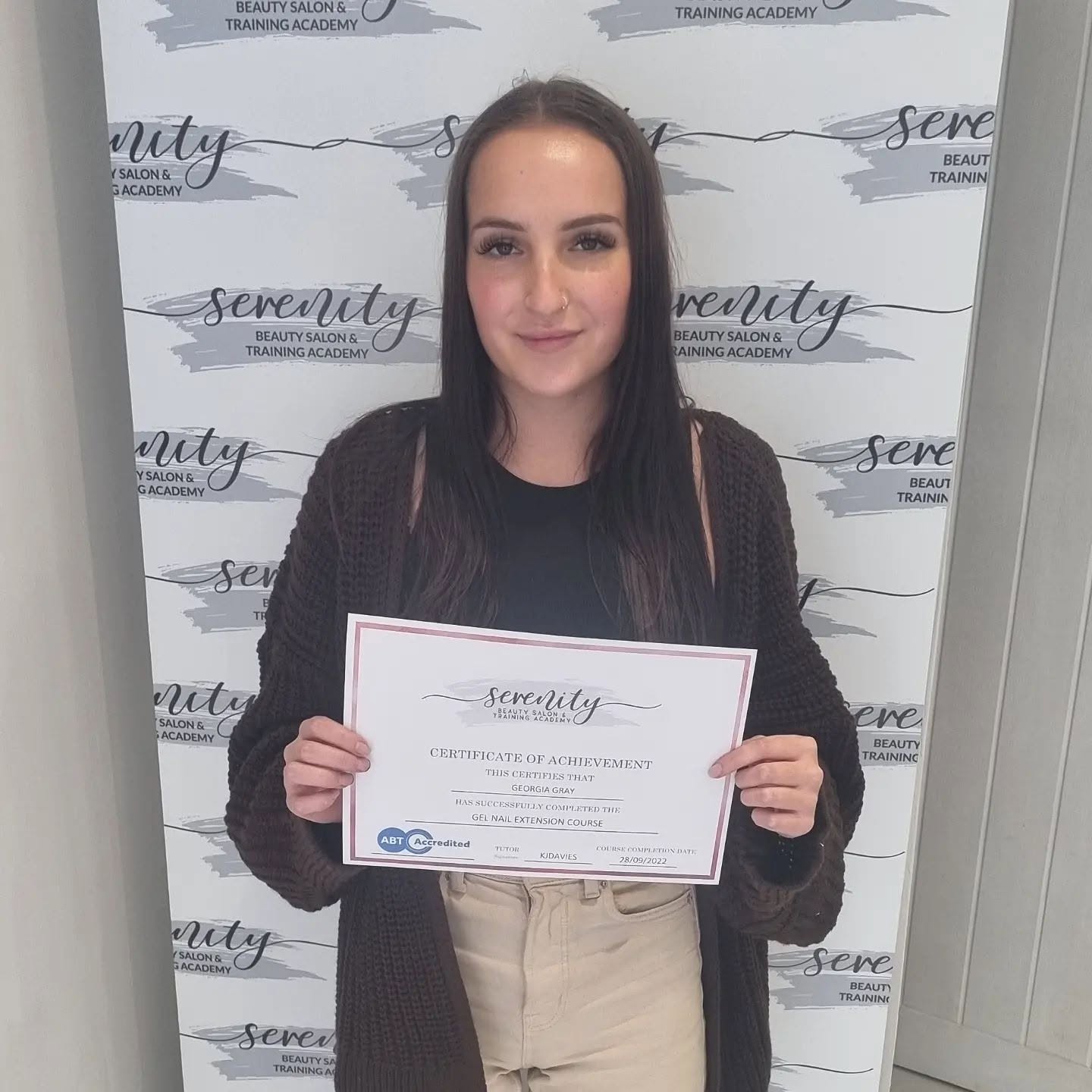A Serenity Training Academy graduate with her certificate
